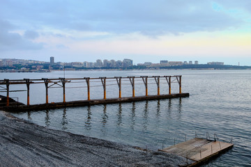 Fototapeta premium Sea at sunset, pier breakwater.