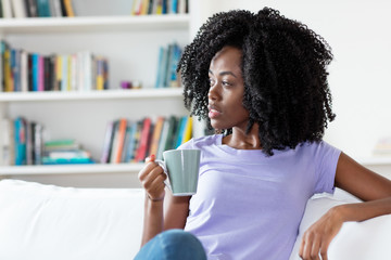 African american woman resting with cup of coffee