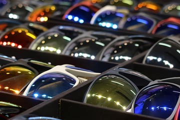 Various coloured sport sunglasses placed in display cases.