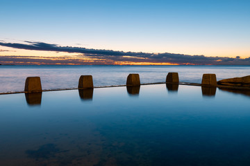 Still water at Coogee rock pool at dawn time.