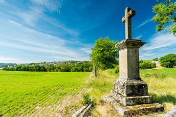 Fototapeta na wymiar A stone cross on the pilgrimage way to Saint Guilhem le Desert