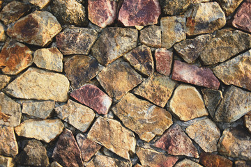 Background texture of natural cracked rock stone wall.