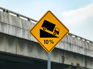 Road sign informs about descending the road. Warning of a steep descent on the road.