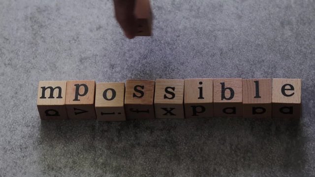 Change impossible to I am possible cube word. Concept idea of can do attitude, positive think and optimistic mindset, self confidence, inspiration and motivation, challenge in carrer and education.