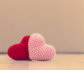 Red and pink hearts on blurred background with copy space.