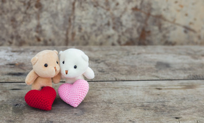Brown and white teddy bears with red and pink hearts. Feeling of joyful together.