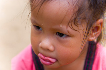 Toddler's Face looking for something and sweaty on her face .