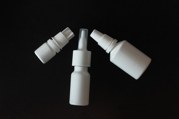 drops and nasal spray white on black background