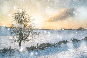 Beautiful snow covered Winter landscape at sunrise in Peak District in England in heavy snow storm