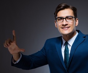 Businessman pressing virtual buttons on gray background