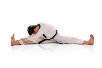 Fototapeta premium Male martial artist split and bend down isolated