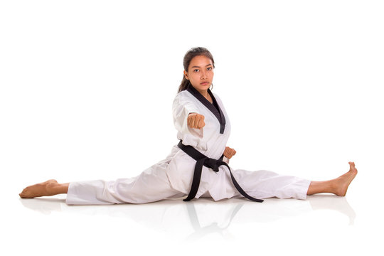 One punch tae kwon do  girl doing split, full length portrait isolated