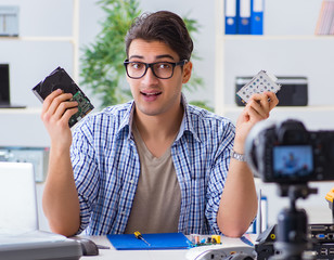 Vlogger recording computer repair on camera for vlog blog
