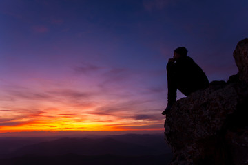 man thinking in sunset landscape
