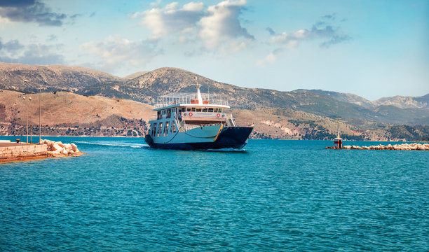Amazing morning view of Lixouri port. Bright spring seascape of Ionian Sea. Wonderful outdoor scene of Cephalonia island with big ferry ship on background.