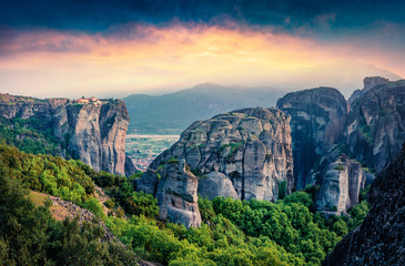 Majestic view of famous Eastern Orthodox monasteries listed as a World Heritage site, built on top of rock pillars. Stunning spring sunset of Kalabaka location,  part of Thessaly, Greece.