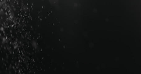 Obraz premium fine dust particles falling on black background