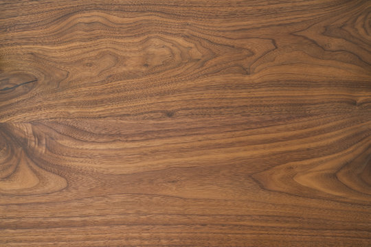 Texture of black walnut table from three boards with oil finish