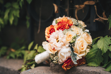 Wedding bouquet made of variety of roses. Outdoor photo