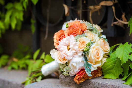 Wedding bouquet made of variety of roses. Outdoor photo