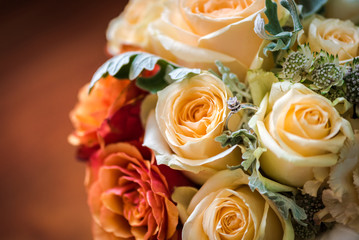 Wedding bouquet mae of roses  and an engagement ring on it