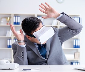 Businessman with virtual reality glasses in modern technology co