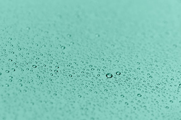 Drops of water on a colored background. Selective focus. Color neo mint.