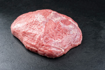 Raw veal topside as closeup on black background with copy space - obrazy, fototapety, plakaty