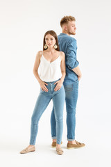 Fashionable young couple in stylish casual clothes on white background