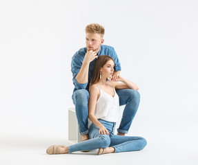 Fototapeta na wymiar Fashionable young couple in stylish casual clothes on white background