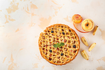 Tasty apple pie on light background