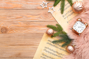 Note sheets and Christmas decor on wooden background