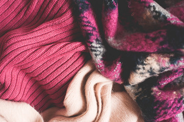 Fototapeta na wymiar Knitted cotton clothes closeup top view. Winter season concept.