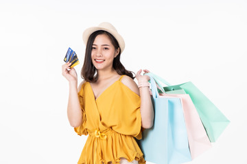 Asian woman in summer casual clothes.Asian Smiling woman .Beautiful Attractive asian woman smile and holding pastel bags on white background,isolated.Shopping happy  concept.