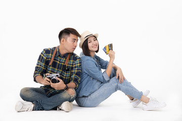 Traveler asian couple with backpack and suitcase standing isolated over white background.Couple Asian  going to summer vacation.Travel trip funny Credit card on holiday.