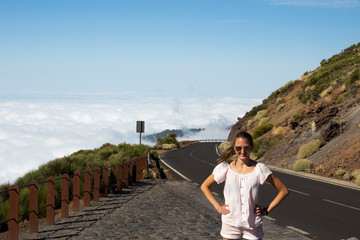 young woman on the road above the clouds - 291247909