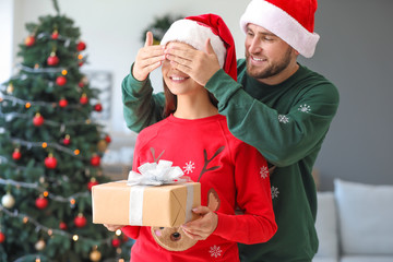 Man giving present to his wife on Christmas eve