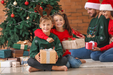 Obraz na płótnie Canvas Happy family with gifts at home on Christmas eve