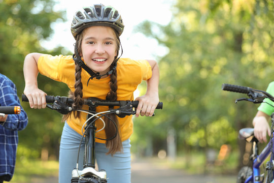 Cute children riding bicycles outdoors