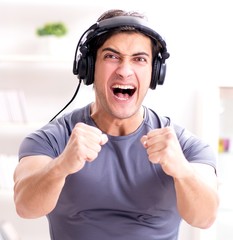 Man doing sports at home and listening to music