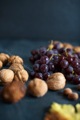 grapes and nuts on a dark marble countertop