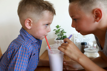 Children drinking vanilla milkshake
