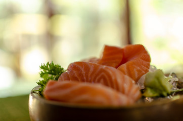 Closeup salmon sashimi on woodden disk