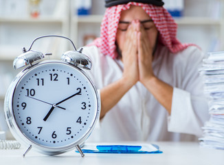 Arab businessman working in the office doing paperwork with a pi
