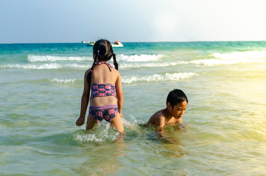 Brather and sister happy to playing at seabord