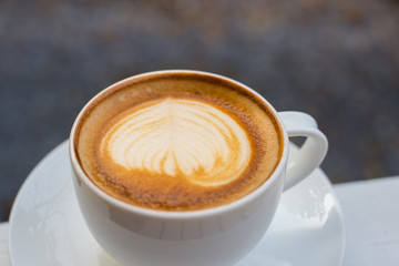 a cup of coffee in white glass,Latte art coffee