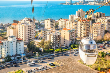 Fototapeta premium Cable car over the residence district with blue sea in the background, Jounieh, Keserwan District,, Lebanon