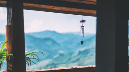 A mobile hanging in the terrace with blurred beautiful mountain background