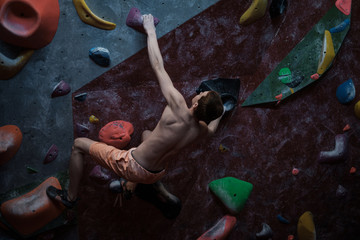 Athletic woman practicing in a bouldering gym © Nejron Photo