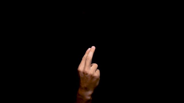 Provocative two finger hand gesture calling out someone in the darkness